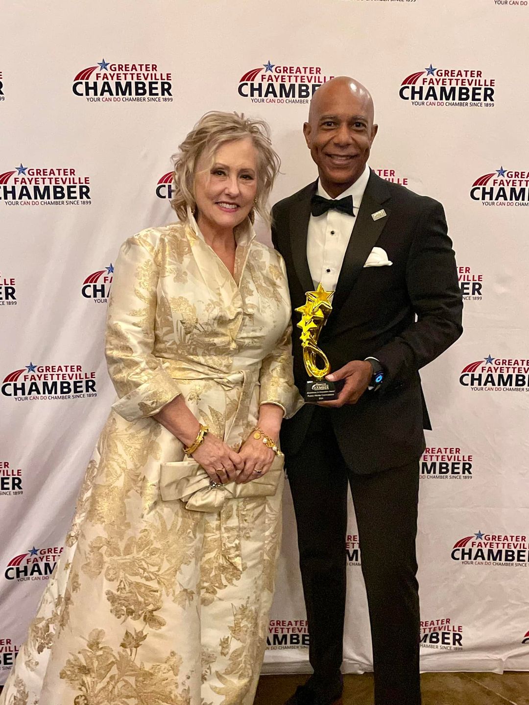 PWC Commissioner Ronna Rowe Garrett & CEO Timothy Bryant pose with the Greater Fayetteville Chamber 2024 Innovation Award